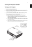 Page 197
EnglishTurning the Projector On/Off
Turning on the Projector
1 Remove the lens cap.(Illustration #1)
2 Ensure that the power cord and signal cable are securely connected.  The 
Power indicator LED will flash red.
3 Turn on the projector by pressing Power button on the control panel, 
and the Power indicator LED will turn blue. (Illustration #2)
4 Turn on your source (computer, notebook, video player ,etc.).  The 
projector will detect your source automatically.
• If the screen displays Lock and Source...