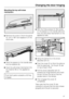 Page 57Mounting the top soft-close
mechanism:
^Remove the coverafrom the panel
b, turn it 180° and replace it on the
other side.
^
Hook the spacer on the handle side
into the retainer (A).
^
Hook the soft-close mechanism into
the retainer (B) on the appliance
side.
Push both parts outwards until they
engage.^With the three screwsc, first screw
on the spacer on the handle side and
then the soft-close mechanism on the
appliance side.
^Hang the panelbon the shock
absorber armd.
^
Push the covereon from the side...