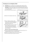 Page 3030
Carrying out an emergency drain
1Warning! Prior to carrying out an emergency drain, switch off the 
washing machine and remove the power plug from the power point.
Warning! The water that comes out of the emergency drain hose may 
be hot. There is a risk of scalding. Let the water cool before performing 
an emergency drain!
1.Open the plinth flap and remove it.
2.Remove the emergency drain hose.
3.Place a shallow container under-
neath it. Then loosen the drain plug 
by turning it in an anti-clockwise...